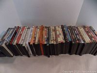 Wide view showing multiple DVD cases aligned horizontally, various titles and genres visible.