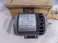 Image showing entire Emerson AC motor with label details, ventilation slots, and mounting base.