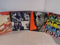 Four vinyl albums by The Rolling Stones displayed side by side showing front covers