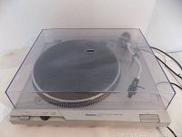 Turntable with dust cover in place, showing overall appearance and condition.