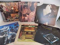 Six classic rock vinyl album covers displayed together: Pat Travers, Linda Ronstadt, Santana, 10CC, The Doobies, Supertramp.