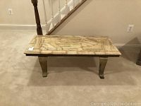 Front view of rectangular coffee table showing marble top and metal legs.