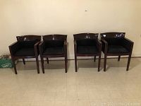 Four Bernhardt armchairs arranged in a row, showing overall condition