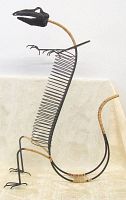Side view of black metal dinosaur shaped CD holder showing wire ribs for CD storage and rattan wrapped neck and tail.