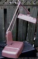 Full side view of lamp extended on platform base