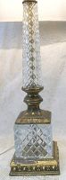 Close-up of lamp base showing cut crystal with diamond pattern and ornate brass details.