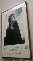 Framed black and white poster showing portrait of Greta Garbo, vertical orientation, framed in wood with glass.
