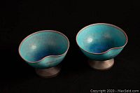 Two Japanese wedding bowls with footed bases shown from the top and front, displaying turquoise and cobalt crystalline glaze with an indentation for holding.