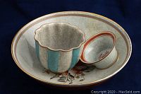 Photo showing the two smaller bowls placed inside the larger floral bowl, highlighting the crackle glaze and design details.