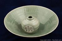 Photo showing both celadon glaze bowl and small vase inside it, highlighting their size difference and glaze color.
