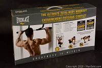 Front view of the Everlast exercise equipment box showing marketing for upper body workouts with a muscular man doing pull-ups. The box states it is designed for a total body workout including push-ups and dips, with workout plans included.