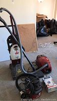 Bissell PowerSteamer upright deep cleaner with DirtLifter Powerbrush and Miele S514 vacuum cleaner with hose.