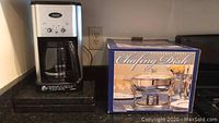 Photo shows Cuisinart coffee maker and boxed stainless steel chafing dish on counter.