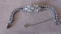 Full length image showing the 7 inch Sherman bracelet with clear stones and fold over clasp with safety chain.