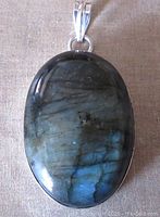Front view of oval labradorite cabochon pendant showing color and surface details.