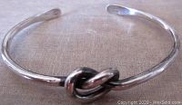 Front view of the vintage sterling silver knot bangle bracelet, showing the knot detail and open cuff design.