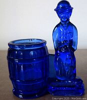 Front view of the cobalt blue glass Charlie Chaplin toothpick holder and barrel container.