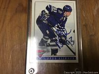 Full view of the Doug Gilmour hockey card in Toronto Maple Leafs uniform, signed in blue ink with number 93, inside a protective sleeve.