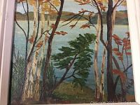 Oil painting of a lakeside scene with trees in foreground and calm water with hills on horizon, framed, signed by artist.
