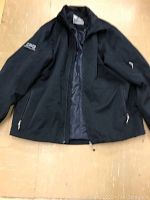 Front view of black men's jacket with CPG embroidery on left arm, showing zipper and pockets.