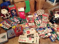 Overview photo showing multiple vintage Christmas items including light sets, wrapping paper rolls, cards, stockings, and figurines.