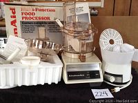 Photo of KitchenAid KFP400 food processor and all accessories laid out with original box and manual visible.