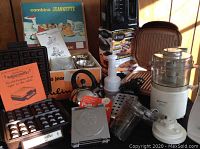 Wide view of all kitchen appliances together including waffle maker box, kettle, coffee maker, food processor, and other items