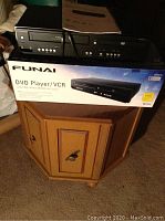 Octagon drum table with the Funai DVD Player/VCR on top, including the product box and manual.