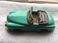 Side angle showing full teal body, maroon seats, and windshield of the tin litho convertible car.