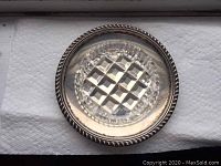 Top view of round sterling silver dish with clear cut glass insert showing rope edge detail.