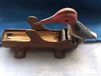 Side angle showing the woodpecker on the base filled with toothpicks.