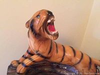 Side view of the tiger lamp figurine with detailed view of the head and mouth open in roar