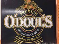 Close-up of O'Doul's Premium Non-Alcoholic Brew logo on black background with gold accents.