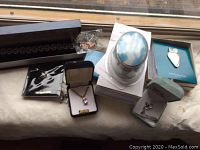 Full lot viewed on window ledge showing multiple jewellery boxes and decorative sphere