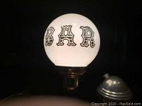 Close-up of the vintage bar light globe showing 'BAR' text in stylized black font on white globe.