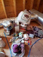 Photo shows a collection of craft supplies including yarn, paper making kit, books, and a metal wire bin