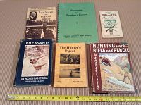 Six books laid out flat showing covers to identify titles and condition
