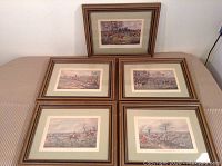 Group of five framed prints arranged on a surface