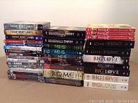 Photo showing multiple stacked DVD sets including Friday Night Lights, Boardwalk Empire, MI-5, The Big C, Game of Thrones, Big Love, and others.