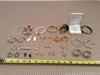 Full view of all jewelry pieces laid out with measuring tape showing length