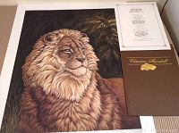 Full view of the signed lion print, showing the lion with a dense mane and dark background along with the COA folder.