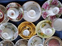 Overhead view of eight tea cup and saucer sets arranged in a tub