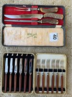 Full view of both sets: upper fitted velvet-lined antler handle carving set and lower woven case holding 6 knives and 6 forks with walnut-colored handles.