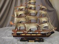 Single large sailing ship model on black base with "Constitution" nameplate