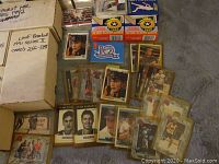 Multiple loose cards and labeled manufacturer boxes on table