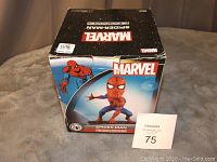 Front and top views of the Marvel Spider-Man Headknocker box showing packaging and branding.