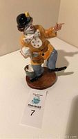 Full view of Royal Doulton The Clown figurine on brown base, showing full body pose and colors