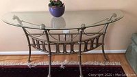 Front view of metal frame foyer table with glass top and decorative rope and lattice detailing, showing condition and style.