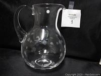 Front view of the Tiffany & Co. etched glass water pitcher showing floral etching and handle.
