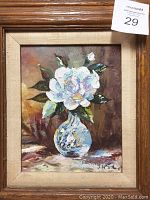 Angle view of framed floral painting to highlight frame texture and matting.